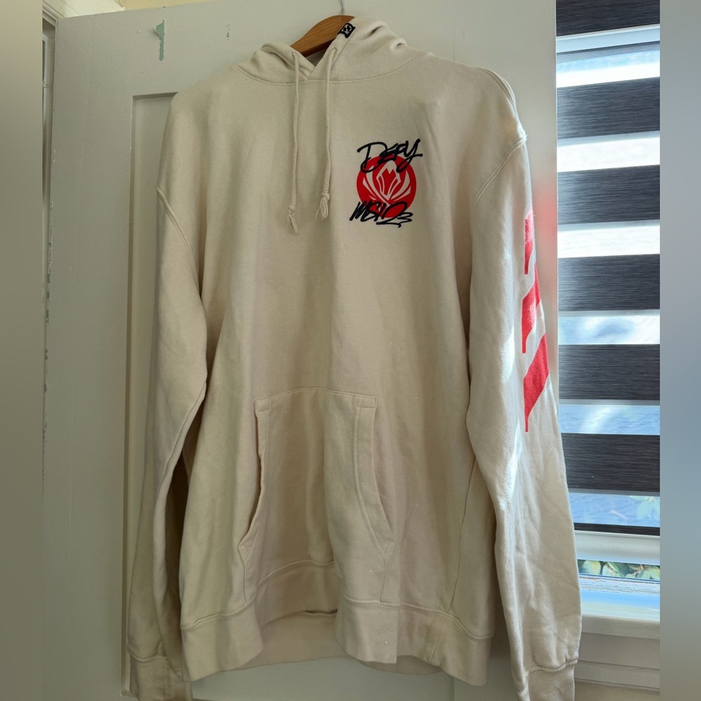 Cream and red Riot Games MSI 2023 Defy hoodie
